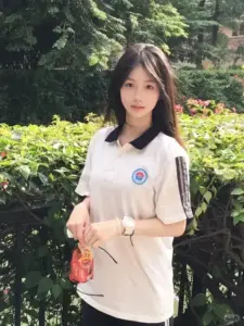 Bên hàng cây xanh, thiếu nữ áo trắng đeo túi hồng, ánh mắt hiền và dáng đứng gọn gàng