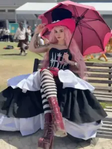 Người đẹp cosplay Vivi đứng giữa nền cung điện trắng, váy xanh bay nhẹ và ánh mắt dịu dàng