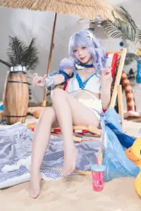 Người đẹp đội tóc giả tím diện bikini trắng ngồi cạnh gối ôm nhân vật với ánh mắt mơ màng