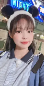 Ảnh chụp đời thường của Nini trong áo sọc xanh, tóc mái thưa và gương mặt trong trẻo