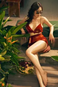 Trong ảnh Phương Oanh mặc bikini đỏ, cô ngồi giữa cây xanh với kính mát tự tin