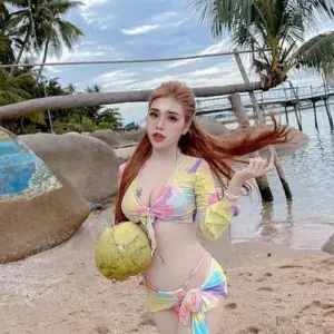 Pinky Bảo Trân diện bikini hoa bên bãi cát, Thân Thùy Bảo Trân cầm dừa với ánh nhìn sắc sảo