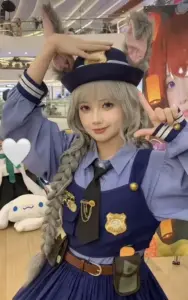 Cô gái cosplay clorinde trong trang phục tím đậm, tay cầm kiếm và gương mặt lạnh đầy khí chất