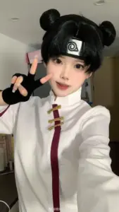 Dáng ngồi vắt chân trên ghế gỗ giúp outfit Naruto lên hình vừa gọn vừa đẹp