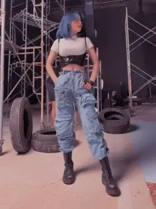 Ánh sân khấu tối, YouTuber Sammy Đào mặc croptop đen, quần jeans, nhìn thẳng tự tin